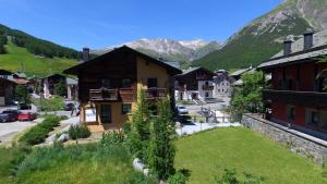 a village in the mountains with mountains in the background at Chalet Layla in Livigno