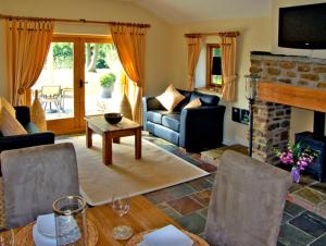 a living room with a couch and a fireplace at Howle Hideaway in Walford