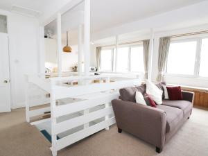 a living room with a white bunk bed and a couch at Top Flat in Tighnabruaich