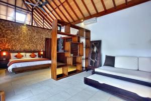a bedroom with two beds and a bunk bed at Villa Esperanto Seminyak in Seminyak +21 photos
