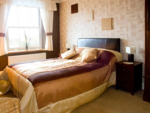 Ένα ή περισσότερα κρεβάτια σε δωμάτιο στο Briarcliffe Cottage