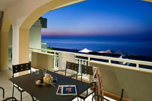 a balcony with a table and a view of the ocean at Casa Vacanze Samira in Fondachello