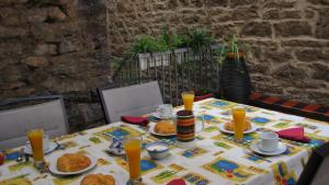 a table with plates of food and orange juice at Hotel Ormazabal in Bergara