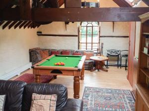 a living room with a pool table in it at Yr Hen Felin in Carrog