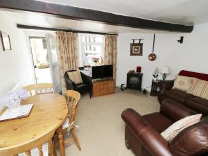a living room with a table and a couch at Black Horse Cottage in Settle