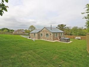 a stone house in a field with a yard at Omalast in Truro