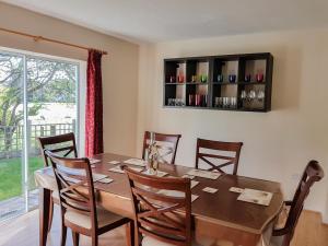 a dining room with a table and chairs and a window at Anglesey White Haven in Llandegfan