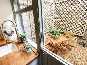 a balcony with a wooden table and a bench at 29 Main Street in Haworth