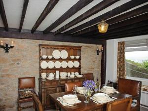 a dining room with a table with plates on it at Blue Horizon in Brixham