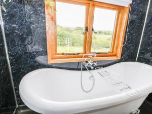 a bathroom with a sink and a window at The Clydes in Tremeirchion