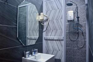 a bathroom with a sink and a shower at Iconic Suites & Pods Hotel in Ipoh +104 photos