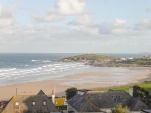 a view of a beach with houses and the ocean at Fistral Outlook in Crantock