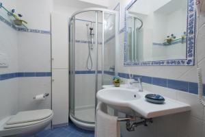 a bathroom with a sink and a shower and a toilet at Casa I Girasoli in Praiano +14 photos