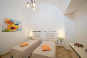 a room with three beds and a painting on the wall at Casa I Girasoli in Praiano