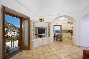 a kitchen and living room with a view of the ocean at Casa I Girasoli in Praiano