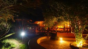 a night time picture of a building with a light at PrideInn Mara Camp & Cottages in Talek