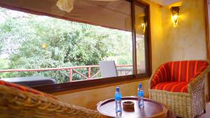 a room with two chairs and a table and a window at PrideInn Mara Camp & Cottages in Talek