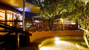 a staircase leading to a building with a balcony at PrideInn Mara Camp & Cottages in Talek