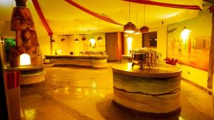 a large room with wine barrels and a bar at PrideInn Mara Camp & Cottages in Talek