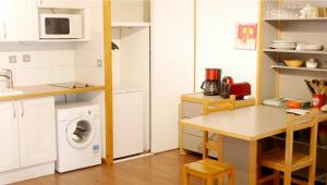 a kitchen with a washer and dryer in a room at Le Grand Chalet - Le Studio in Brides-les-Bains