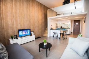 a living room with a couch and a tv at KL Sentral Bangsar Suites (EST) by Luxury Suites Asia in Kuala Lumpur