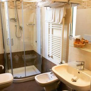 a bathroom with a shower and a sink and a toilet at Hotel Villa Igea in Alassio +83 photos