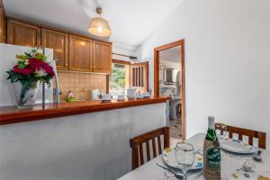 a kitchen with a table with a bottle of wine at Areti Apartments in Póros Kefalonias