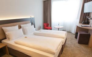Postel nebo postele na pokoji v ubytování Astor & Aparthotel