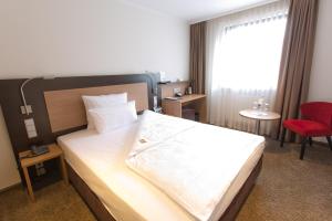 Postel nebo postele na pokoji v ubytování Astor & Aparthotel