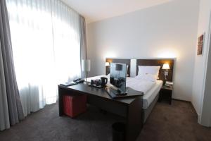 Postel nebo postele na pokoji v ubytování Astor & Aparthotel