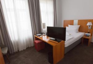 Postel nebo postele na pokoji v ubytování Astor & Aparthotel