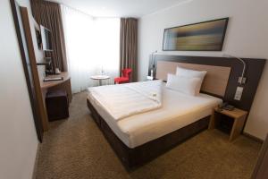 Postel nebo postele na pokoji v ubytování Astor & Aparthotel