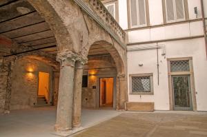 an old building with an archway in a courtyard at ReGo Apartments in Bergamo