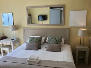 a bedroom with a large bed with a mirror on the wall at Life on 3rd in Johannesburg