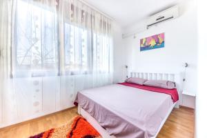 a bedroom with a bed and a window at Charming City Center in Podgorica