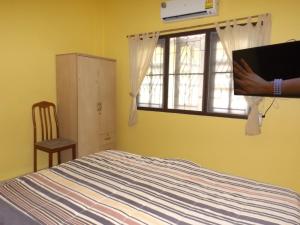 a person holding a picture of a bed in a bedroom at Mango House in Lamai