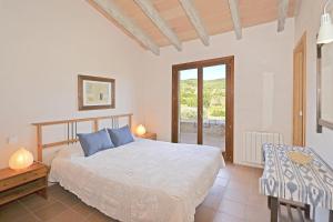a bedroom with a bed and a table and a window at Villa Font in Artá +37 photos