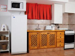 a kitchen with a white refrigerator and a sink at Los Molles Complejo Turistico in Los Molles +38 photos