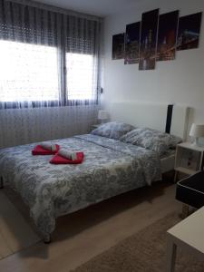 a bedroom with a bed with red towels on it at Studio Apartman Marija in Zagreb