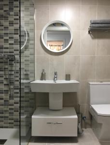 a bathroom with a sink and a mirror at Apartment Santa Teresa in Altea