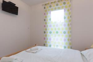 Postel nebo postele na pokoji v ubytování Apartments Karen