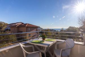 a table and chairs on a balcony with a view at Apartments Karen in Krk
