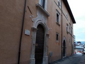 an entrance to a building with a door at B&B Palazzo Cappa in LʼAquila