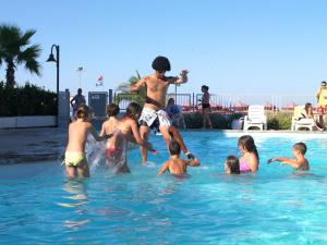 a group of children playing in a swimming pool at Casa Del Mar in Roseto degli Abruzzi