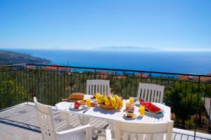 a white table with food on top of a balcony at Summer Dream in Vlachata