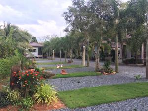 a garden with trees and flowers in a yard at Big House Resort in Trat
