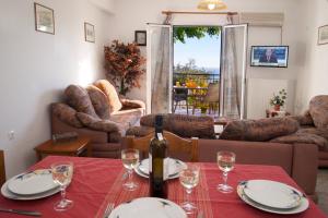 a living room with a table with a bottle of wine at Summer Dream in Vlachata