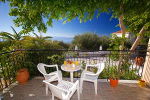 a table and chairs on a patio with a view at Summer Dream in Vlachata