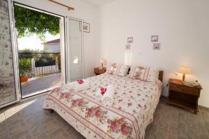a bedroom with a bed and a large window at Summer Dream in Vlachata