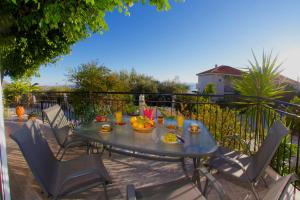 a table with a bowl of fruit on a balcony at Summer Dream in Vlachata
